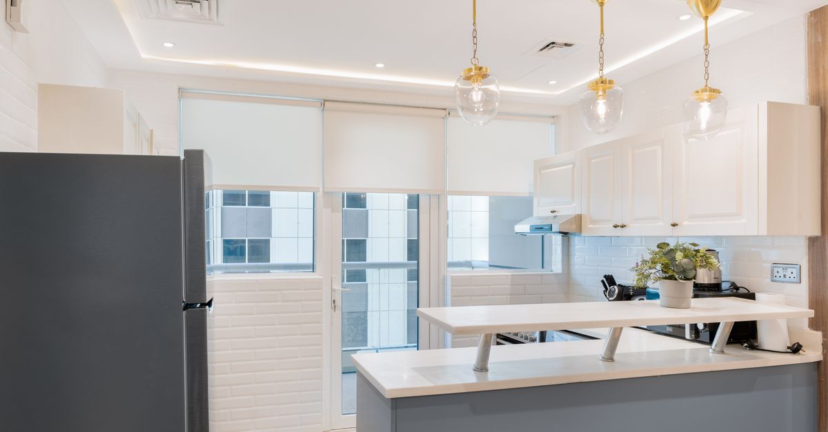 Explore a contemporary kitchen featuring elegant lighting and chic decor, blending style and function.