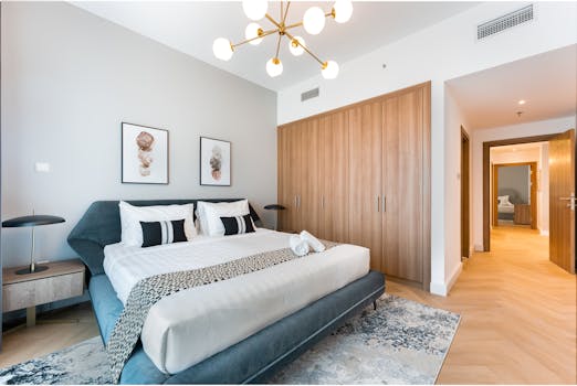 Sleek modern bedroom featuring elegant furniture, cozy decor, and stylish lighting.