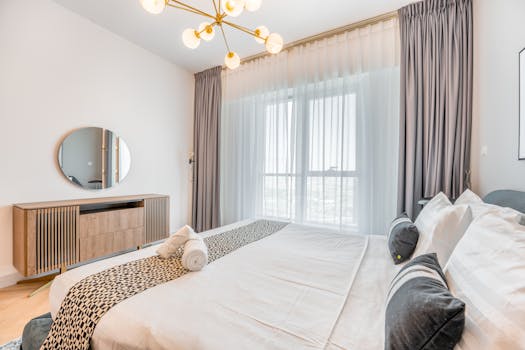 Spacious modern bedroom with elegant design and natural light.