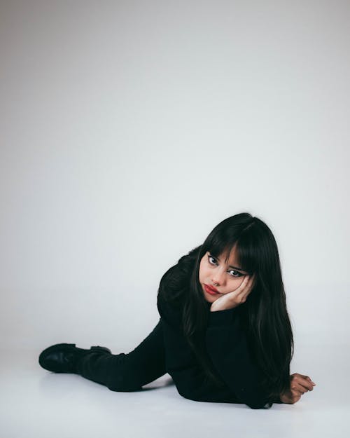 Young Woman in Black Lying on the Floor 