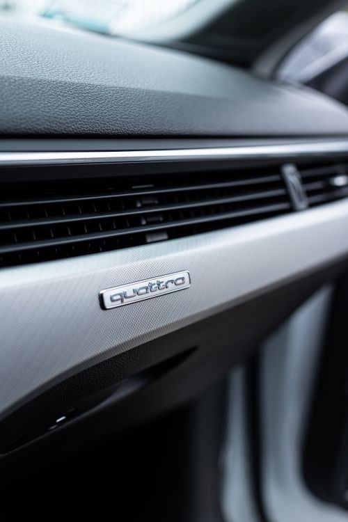 Free Sleek interior shot highlighting the Quattro emblem on a car dashboard. Stock Photo