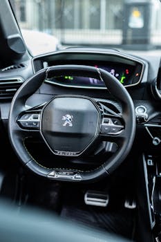 Detailed view of a car steering wheel showcasing modern design inside a vehicle.