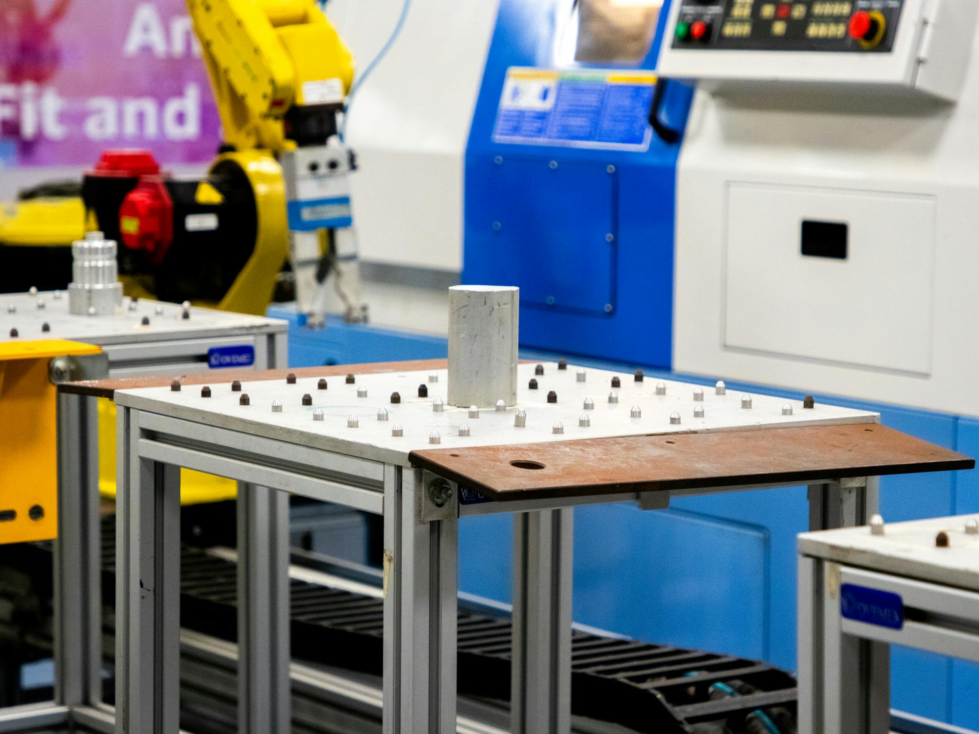 A machine with a robot arm and a table
