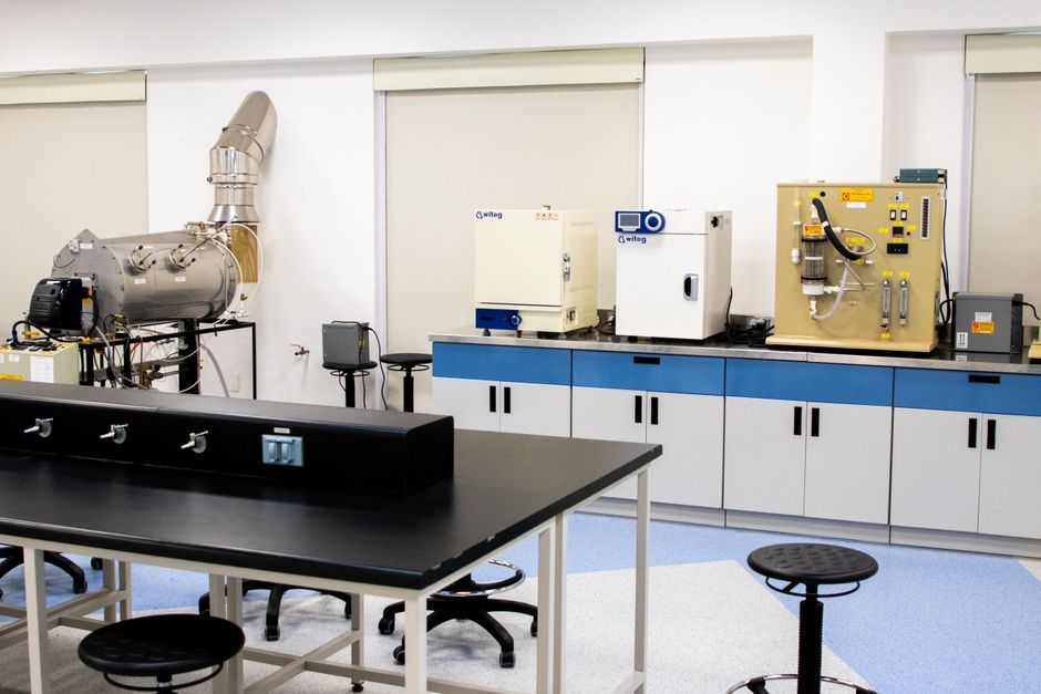 Empty research laboratory with bench and equipment — ibogaine's mechanism for PTSD involves GDNF upregulation, NMDA receptor modulation, and disruption of fear memory pathways in the amygdala and hippocampus