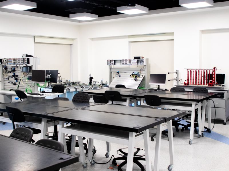 A contemporary classroom equipped with advanced technological tools and workstations.