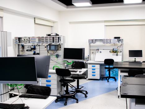 Bright modern laboratory with computers and technical equipment for research and analysis.