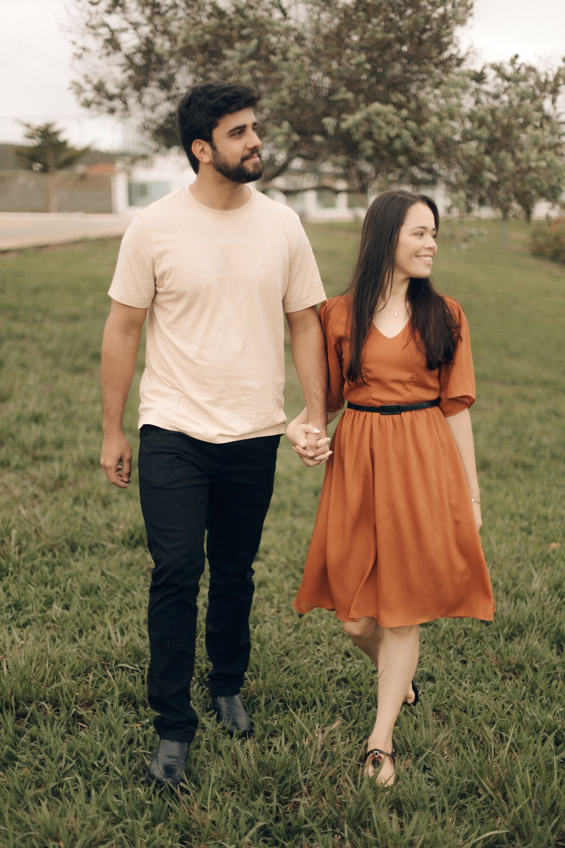 Young Couple Walking on Lawn Hand in Hand · Free Stock Photo