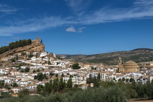 Free Aerial view of the picturesque town of Montefrío, Spain with its iconic clifftop church and surrounding landscape. Stock Photo