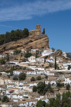 Breathtaking view of Montefrío, Spain, featuring the historic hilltop church and white village houses.