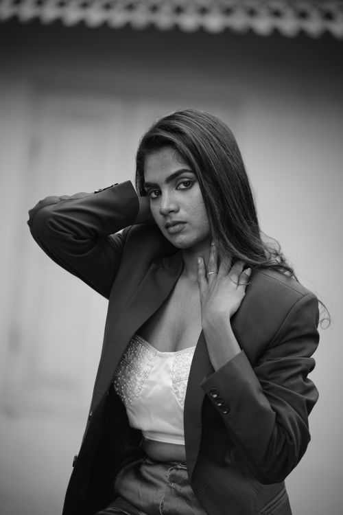 Free A stylish monochrome portrait of a young South Asian woman in a jacket and white top. Stock Photo