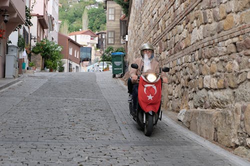Man on a Motor Scooter with a Turkish Flag