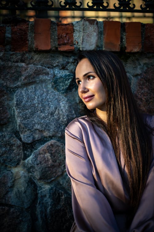 Portrait of Woman by Stone Wall