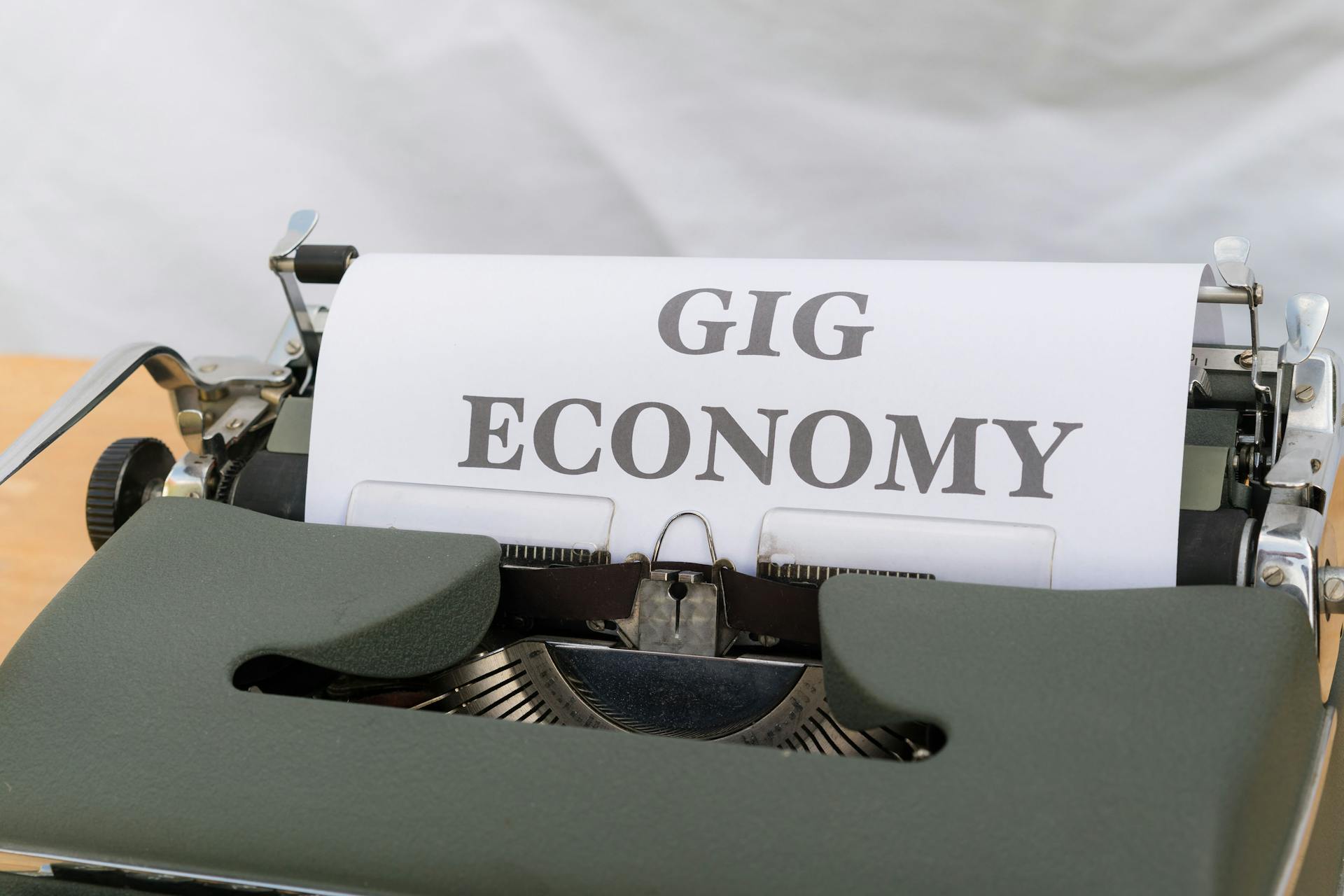 Close-up of a typewriter typing 'Gig Economy', symbolizing modern freelance work.