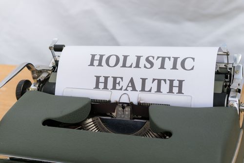 Free Close-up of a vintage typewriter with 'Holistic Health' typed on paper, symbolizing wellness. Stock Photo