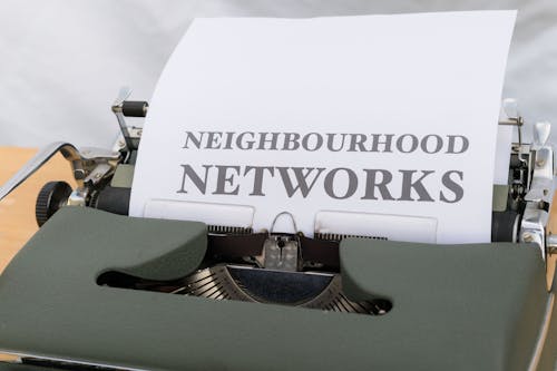 A typewriter with a paper that says neighborhood networks
