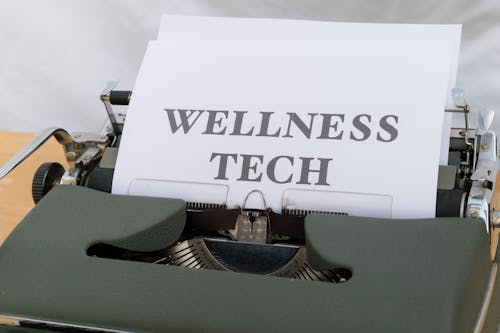 A typewriter with the word wellness tech on it