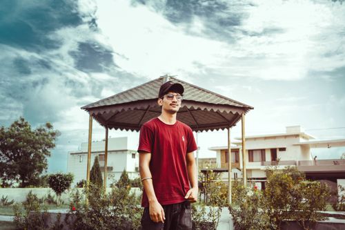 Free Casual portrait of a man with sunglasses and cap in an urban gazebo setting, Barnala, India. Stock Photo