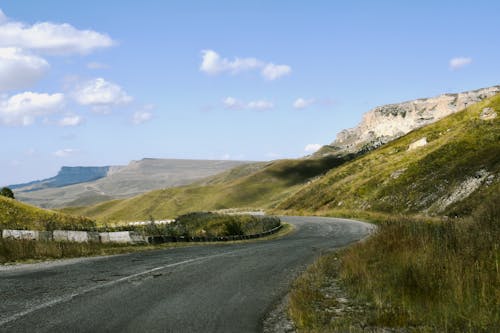 Empty Road on Hills in Countryside