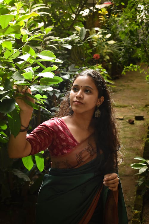 Woman in Traditional Clothing Standing near Tree