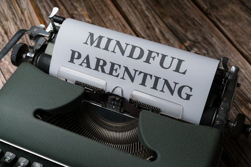 A typewriter with the word mindful parenting written on it