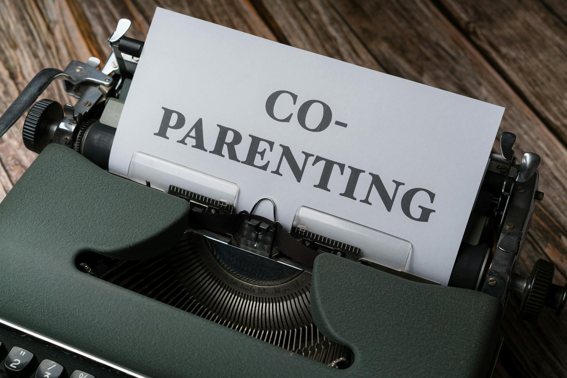 Close-up of a typewriter with a co-parenting document, symbolizing effective collaboration.