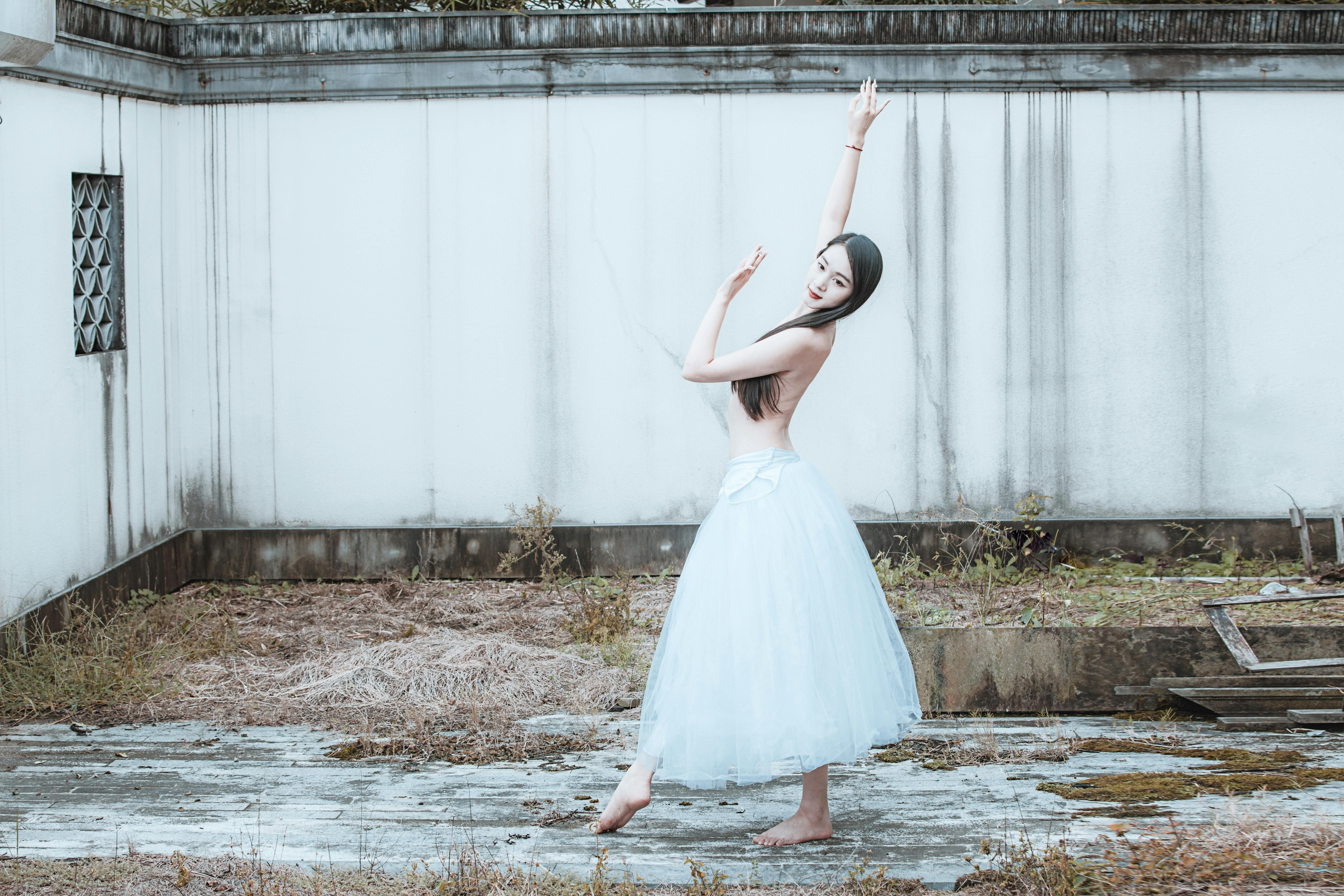 Topless Woman Dancing and Posing in White Skirt · Free Stock Photo