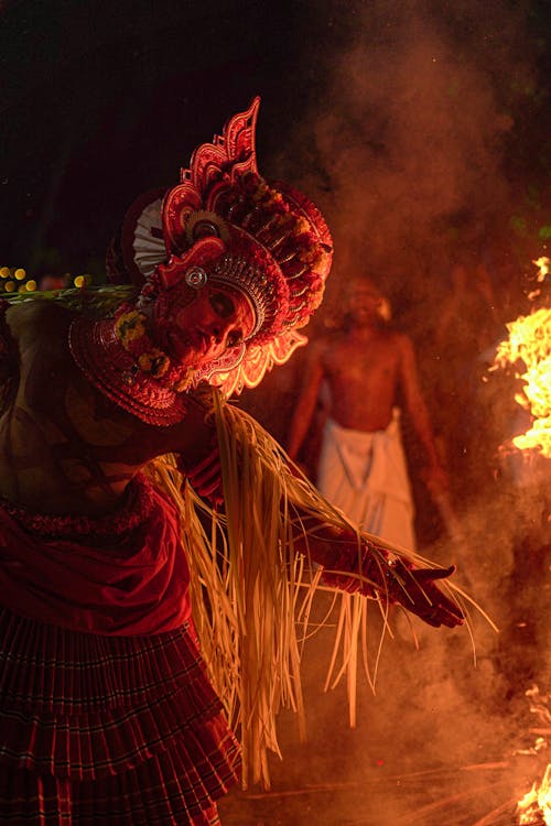 Person in a Costume Dancing by the Fire