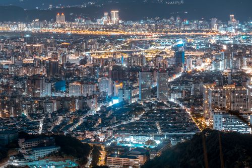 Free A breathtaking night aerial view of a vibrant cityscape, showcasing modern architecture and illuminated downtown areas. Stock Photo