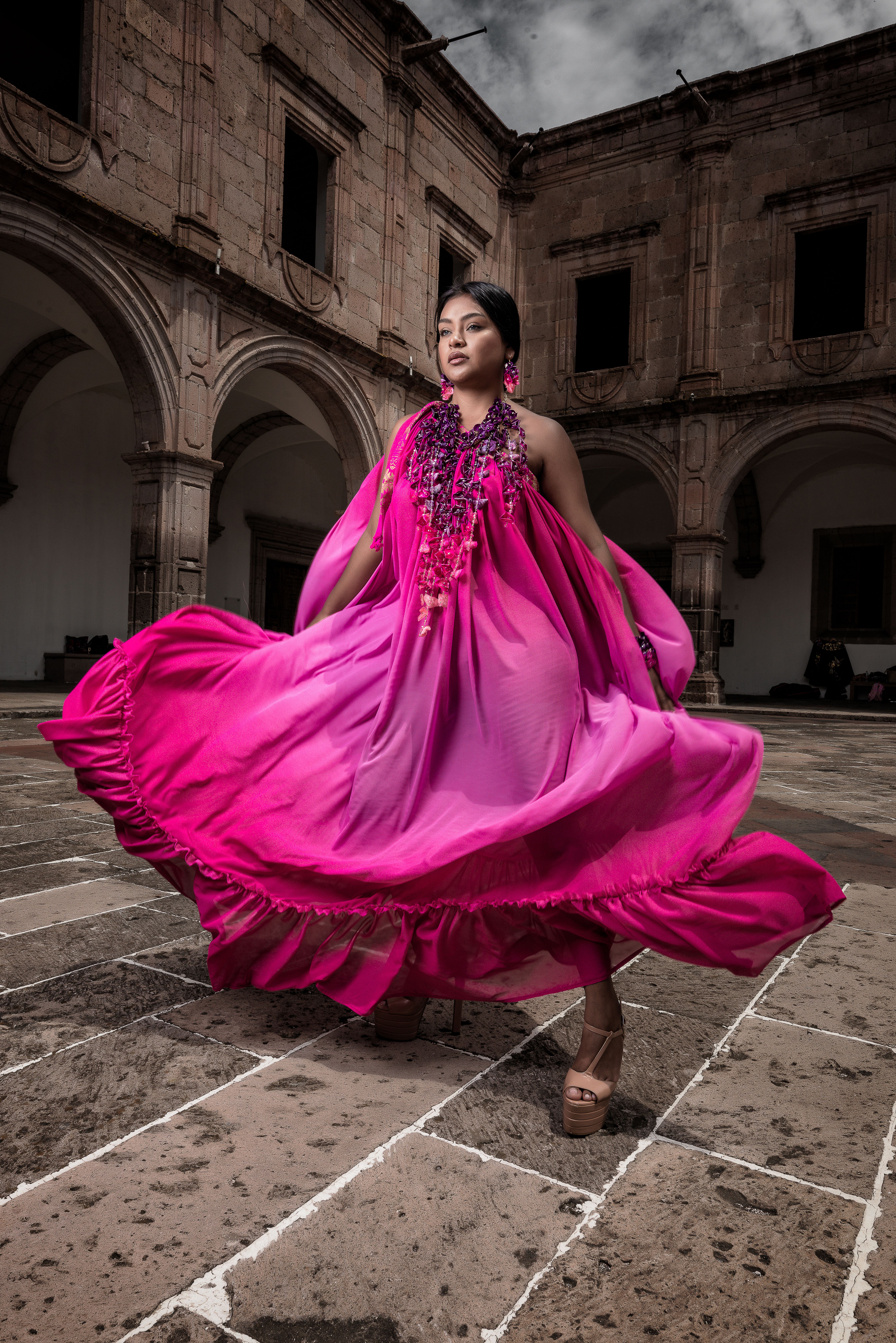 Brunette Woman in Pink Dress Posing in Courtyard · Free Stock Photo