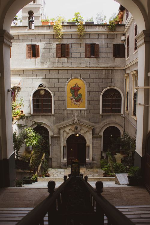 Free A historical courtyard with stone facade and artwork nestled in Istanbul, showcasing architectural charm. Stock Photo