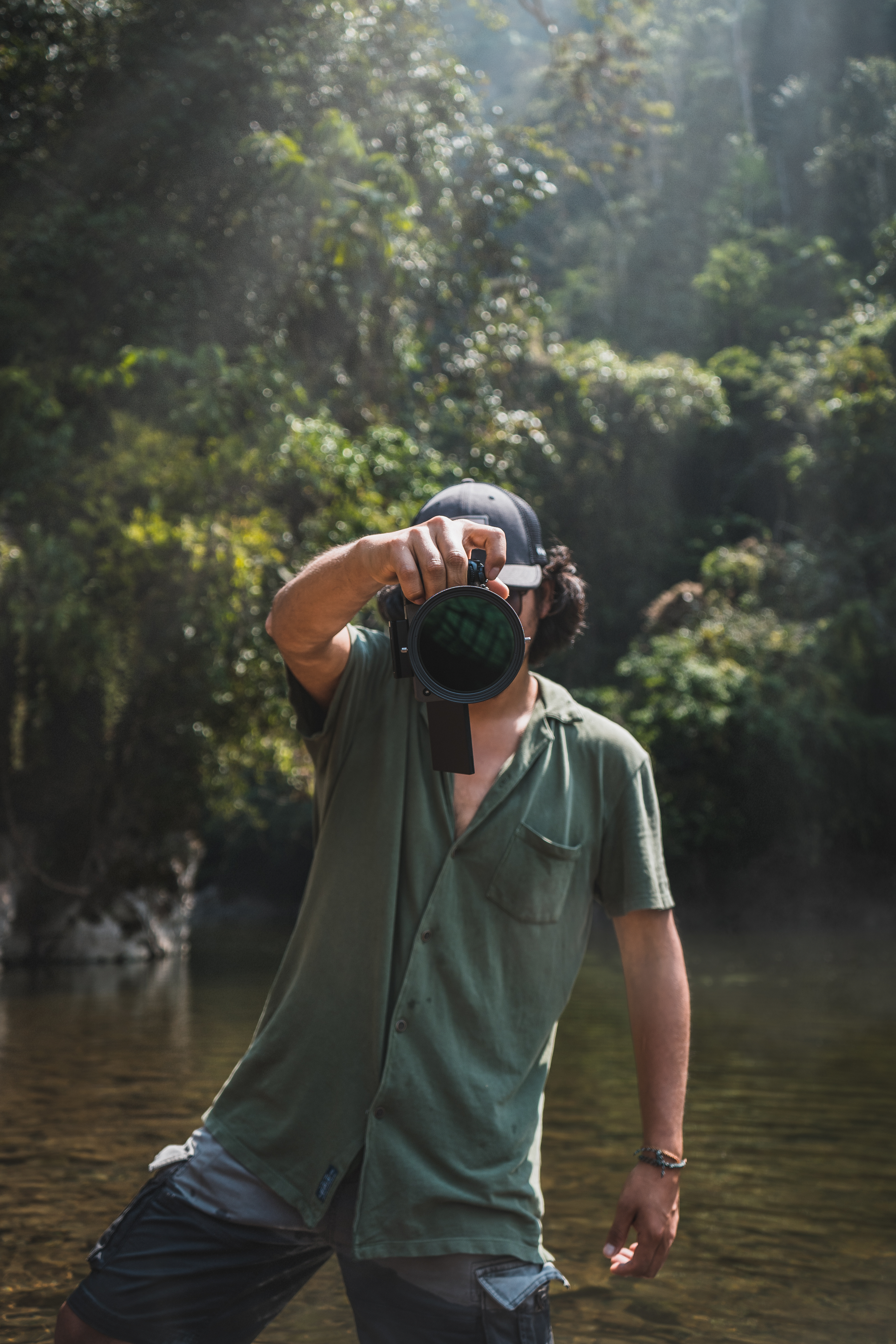 A man capturing photos in the lush jungle of Rioja, San Martín, Peru.