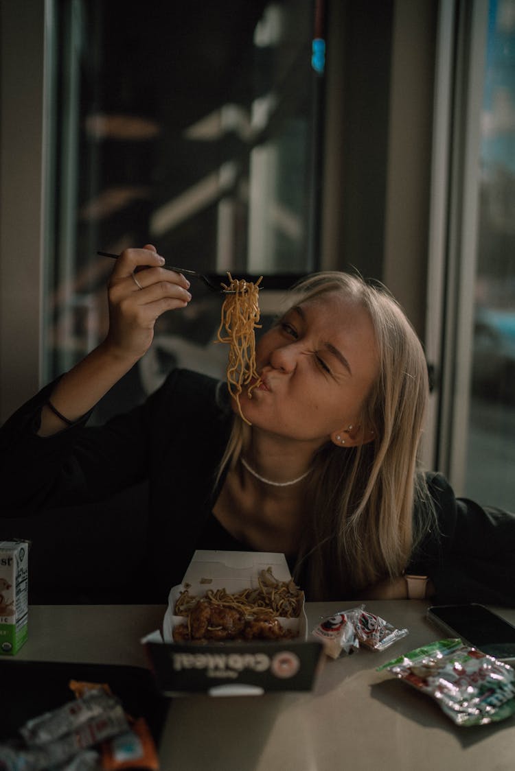 Woman Eating Noodles