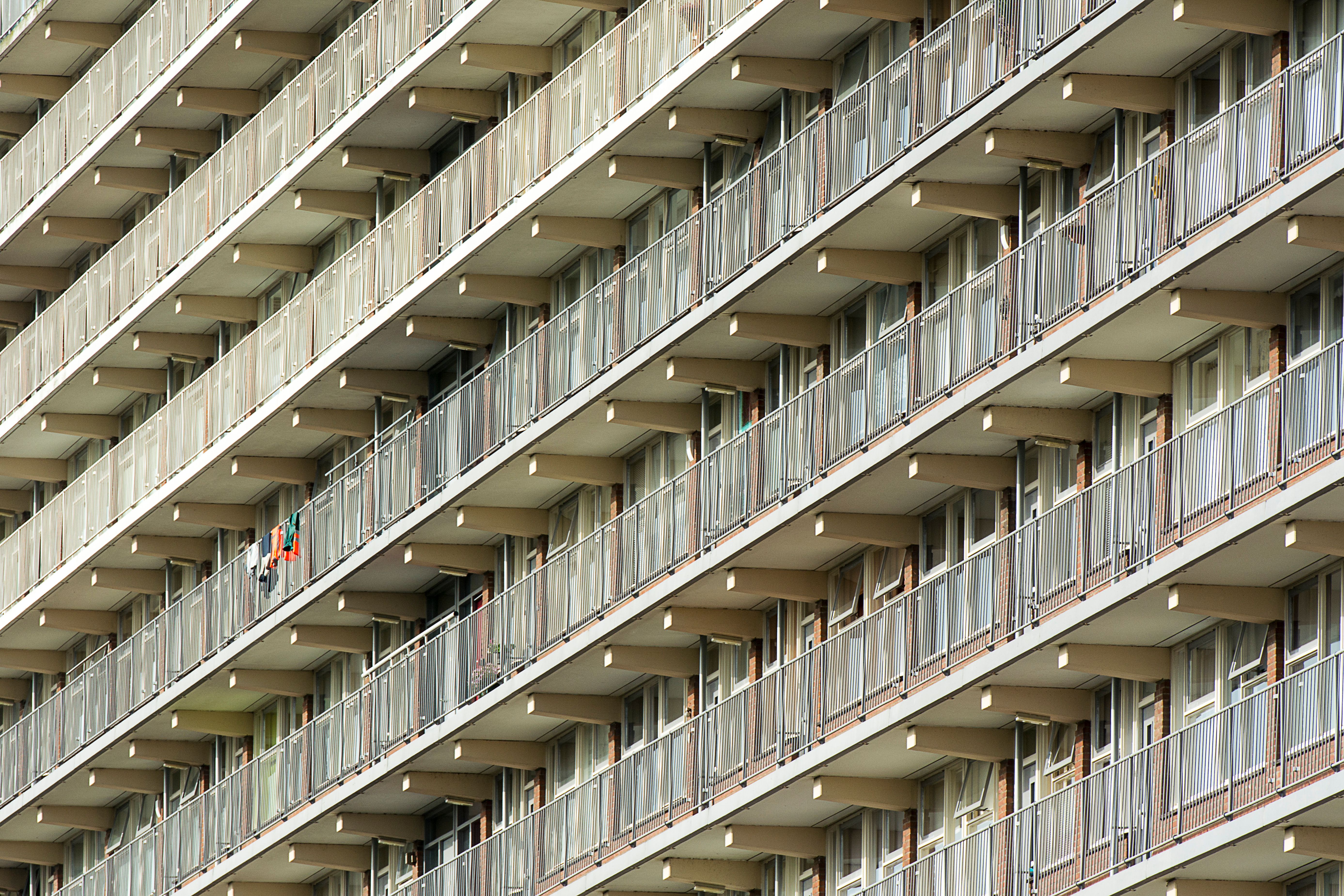 Close-up view of a modern apartment building with repetitive balcony pattern.