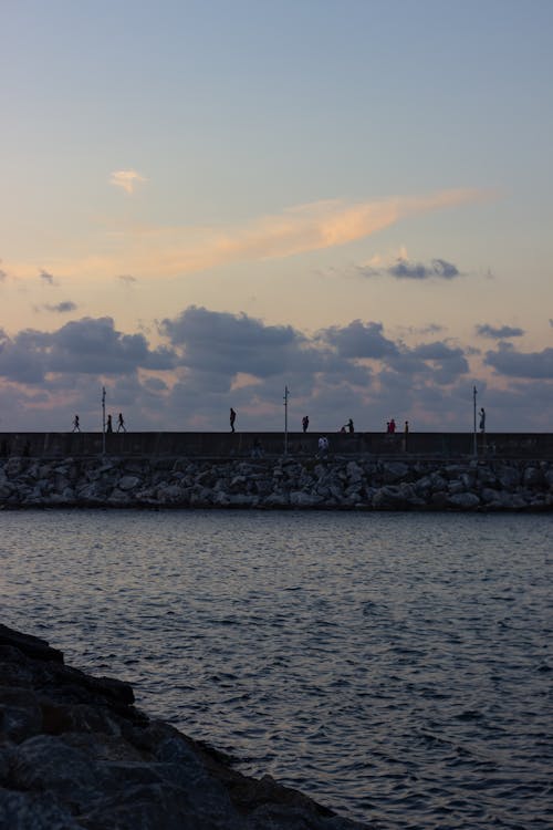 People walking on breakwater