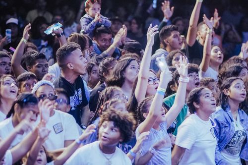 Free Diverse audience enjoying a vibrant concert experience with energy and enthusiasm. Stock Photo