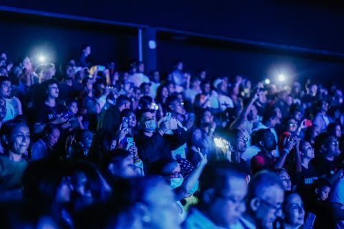 Free A lively crowd at a concert with flashlights illuminating the atmosphere. Stock Photo