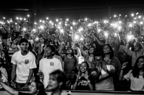 Free Black and white image of an energetic concert crowd holding up flashlights. Stock Photo