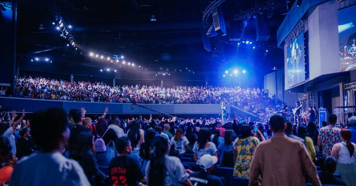 Interior of Christ Embassy Loveworld Arena showing the stage and congregation