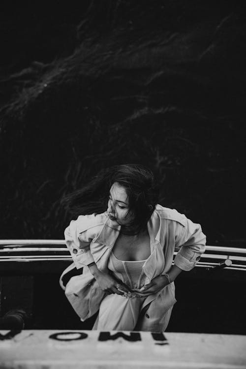A woman sitting on the edge of a boat