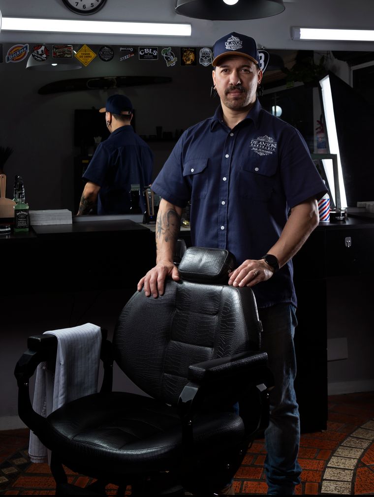 Barber standing beside a barber chair