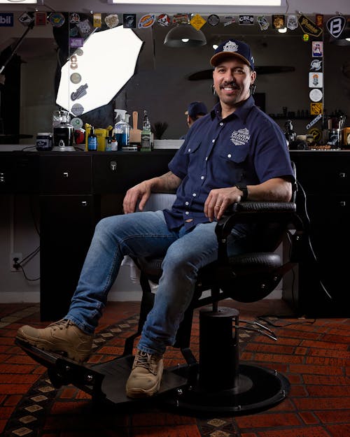 Smiling Man Sitting on a Barber Chair
