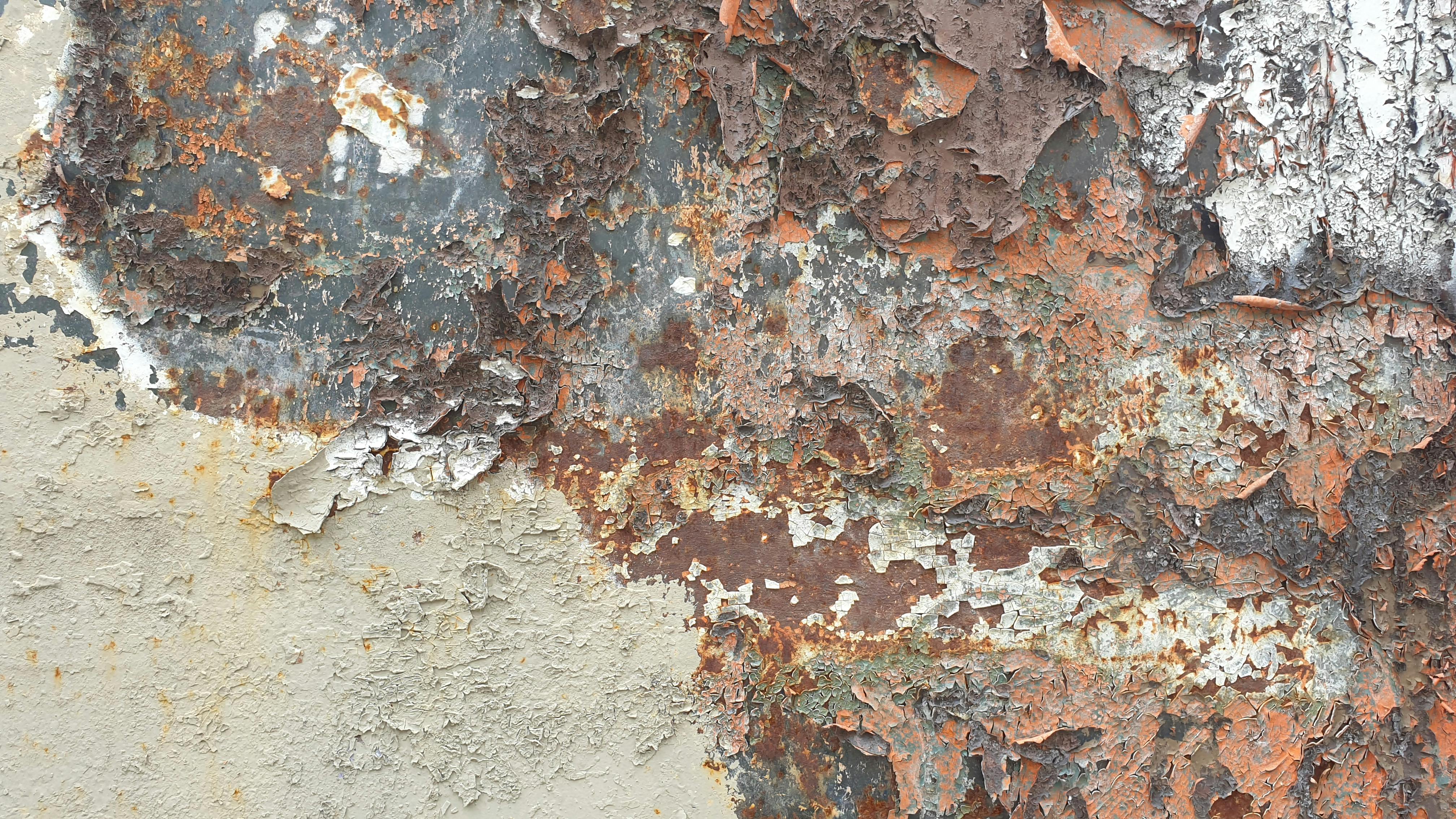 Detailed image of rustic, peeling paint on metal with rich textures.