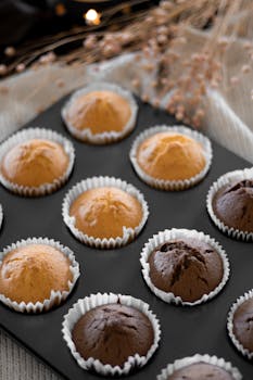 Delicious vanilla and chocolate cupcakes in a tray, perfect for sweet snacks.