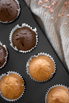 A top view of freshly baked chocolate and vanilla muffins in a tray.