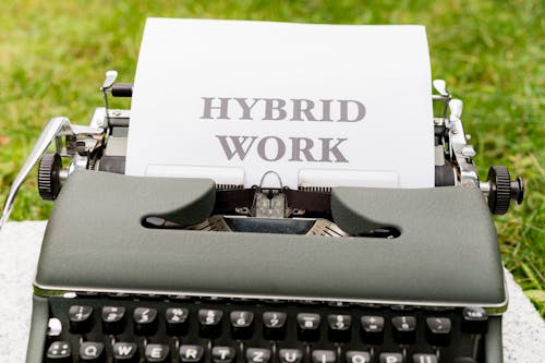 A typewriter with the words hybrid work on it