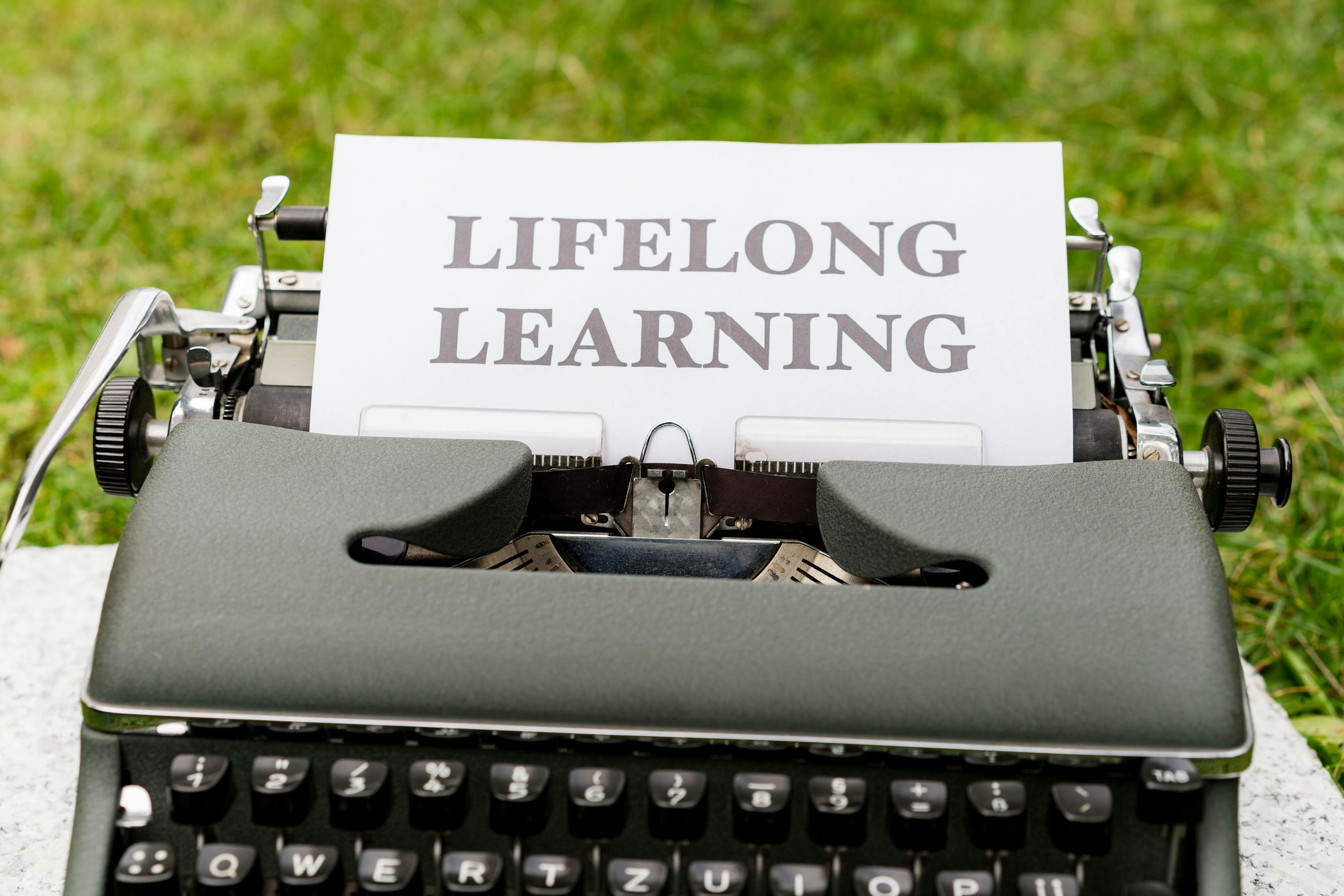 a typewriter with a paper that says life long learning