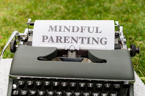 A typewriter with the word mindful parenting written on it