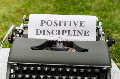 A typewriter with the word positive discipline written on it