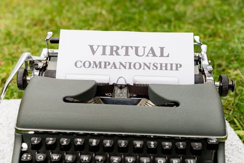 A typewriter with a paper that says virtual compassion