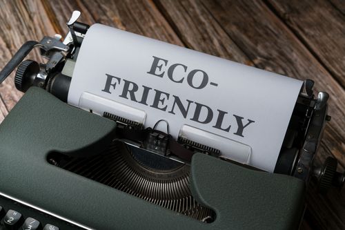 Free Close-up of a vintage typewriter displaying 'Eco-Friendly' on paper, promoting sustainability. Stock Photo